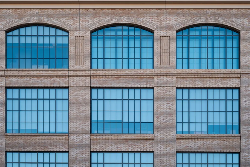 The brick and steel window facade of a converted commercial building